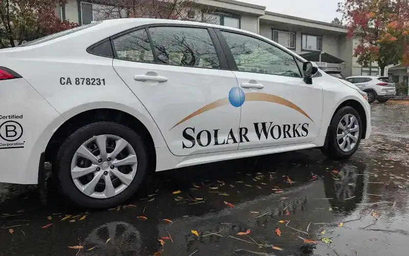 company car with logo decals on it